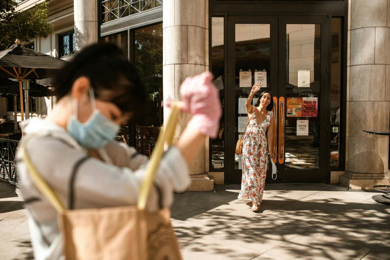 a woman taking a picture of herself in front of a building, by Meredith Dillman, pexels contest winner, action painting, starbucks aprons and visors, feng zhu |, waving robe movement, shuttered mall store