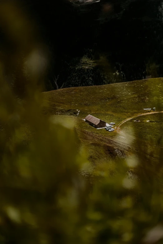 a man riding a bike down a dirt road, a tilt shift photo, by Peter Churcher, renaissance, alpine landscape with a cottage, lit from above, scale model photography, shot from cinematic