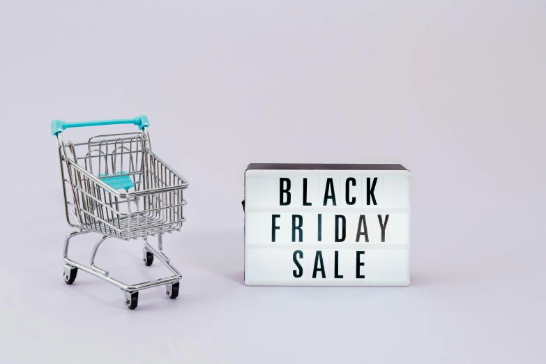 a shopping cart next to a black friday sale sign, hurufiyya, press shot, with a white background, dark. no text, slate