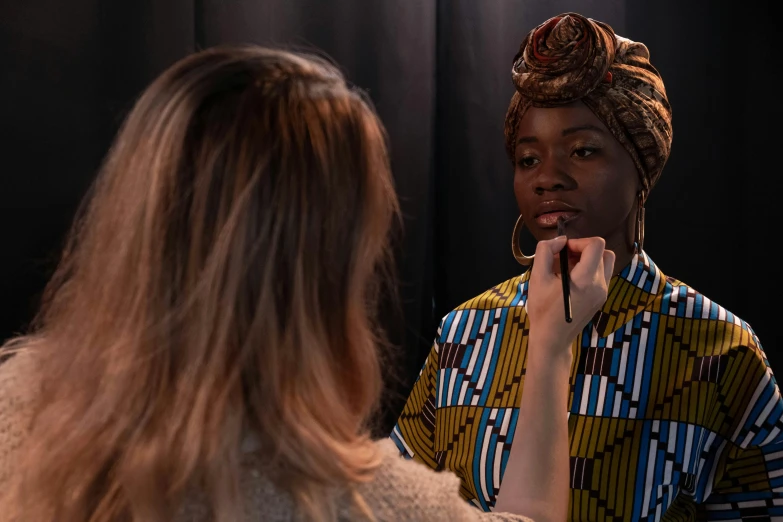 a woman brushing her teeth in front of a mirror, pexels contest winner, hyperrealism, cloth head wrap, on set, wearing professional makeup, brown