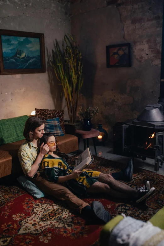 a man and a woman sitting on a rug in a living room, inspired by Elsa Bleda, unsplash contest winner, cosy fireplace, vhs style, promo image, national geographic photo shoot