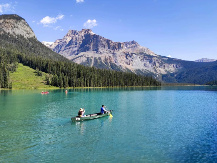 a couple of people in a canoe on a lake, by Emma Lampert Cooper, pexels contest winner, bakelite rocky mountains, crystal clear blue water, cory chase, gondola