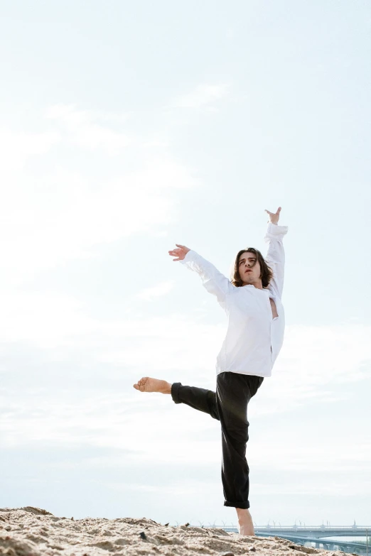 a woman standing on top of a sandy beach, unsplash, arabesque, uniform off - white sky, triumphant pose, concert, with a white background