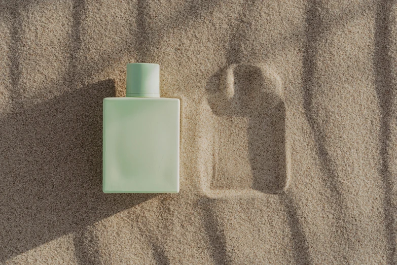 a bottle of perfume sitting in the sand, inspired by Raoul De Keyser, gradient pastel green, trending on dezeen, tonal colors outdoor, sparse chest hair