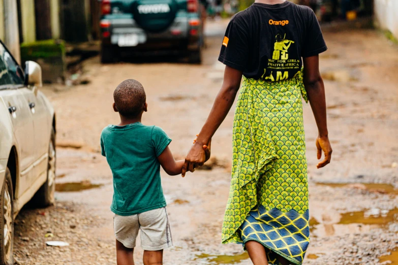 a woman and a child walking down a street, by Ingrida Kadaka, pexels contest winner, happening, masculinity, obunga, holding hands, thumbnail