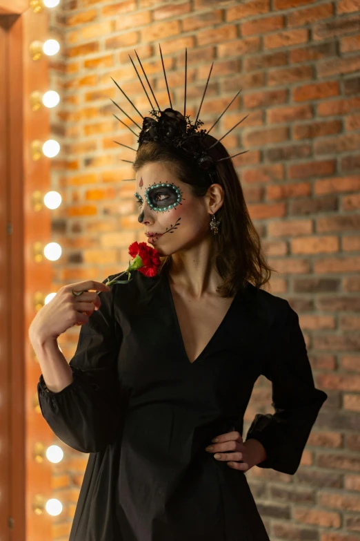 a woman in a black dress with a rose in her hand, inspired by Kahlo, pexels contest winner, dia de los muertos makeup, portrait of lucha libre dj, square, head to waist