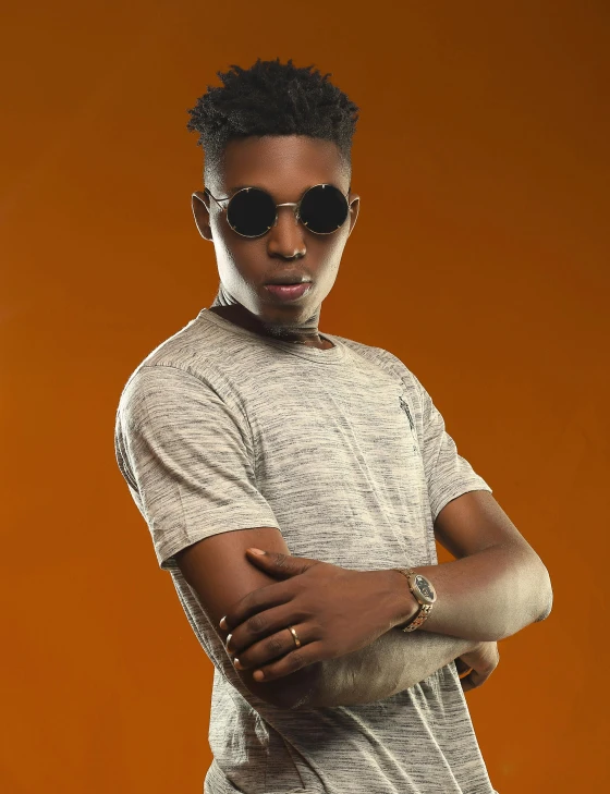 a young man standing with his arms crossed, an album cover, by Chinwe Chukwuogo-Roy, trending on pexels, androgynous male, shades, 15081959 21121991 01012000 4k, halfbody headshot