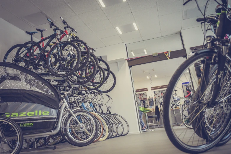 a room filled with lots of bikes next to each other, by Daniel Lieske, dribble, verdadism, profile image, indoor picture, store, helmond