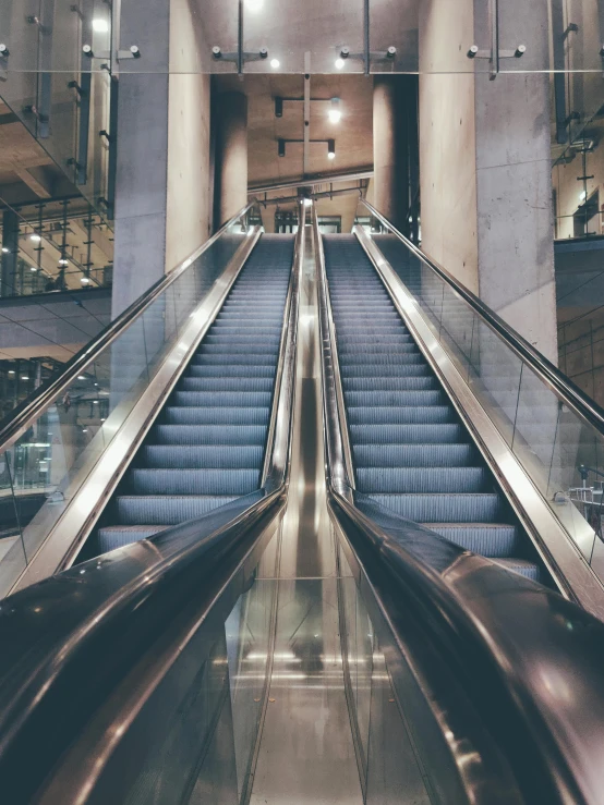 a couple of escalators sitting next to each other, profile image, thumbnail, inside the building, multiple stories