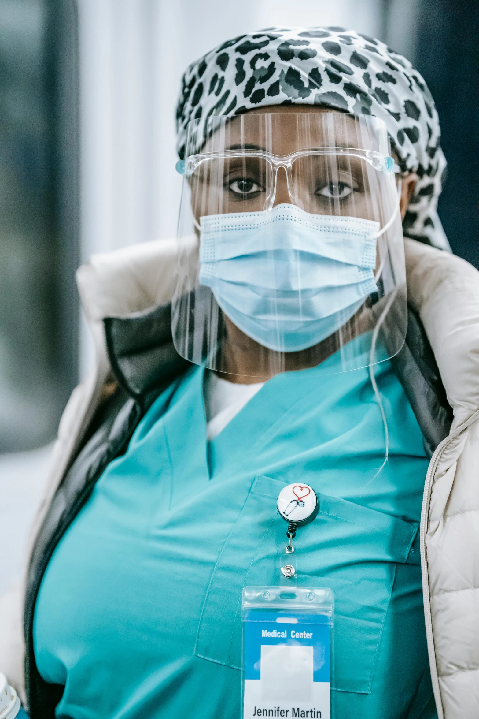 a close up of a person wearing a face mask, a picture, surgical gown and scrubs on, essence, documentary, transparent