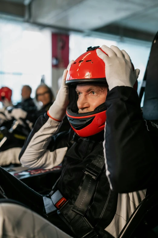 a man sitting in a race car with a helmet on, inspired by Hendrick Cornelisz Vroom, happening, peak experience ”, soft rubber, head on