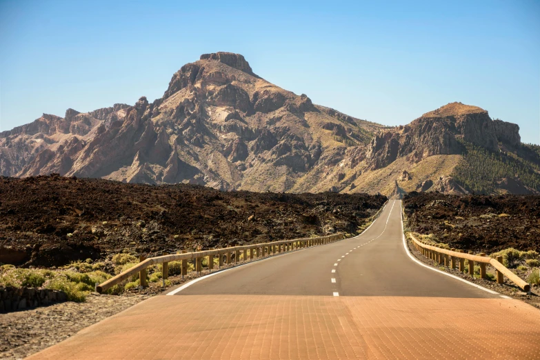 an empty road with mountains in the background, a picture, square, volcanic, brown, boroque