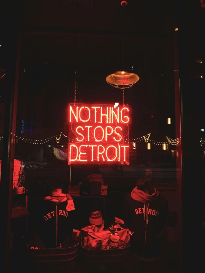 a neon sign that says nothing stops detroit, a photo, trending on unsplash, 💋 💄 👠 👗, shopwindows, not ruins, nightcap