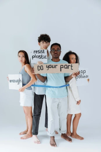 a group of people standing next to each other holding signs, pexels contest winner, plasticien, plastic and fabric, avatar image, recycled, ( ( theatrical ) )