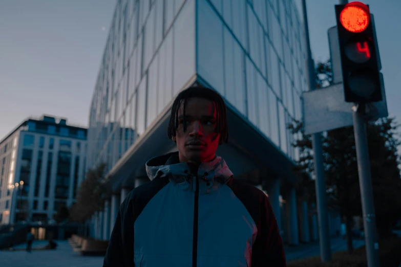 a man standing in front of a traffic light, unsplash contest winner, realism, chappie in an adidas track suit, perfectly lit face, reflective puffy coat, overcast! cinematic focus