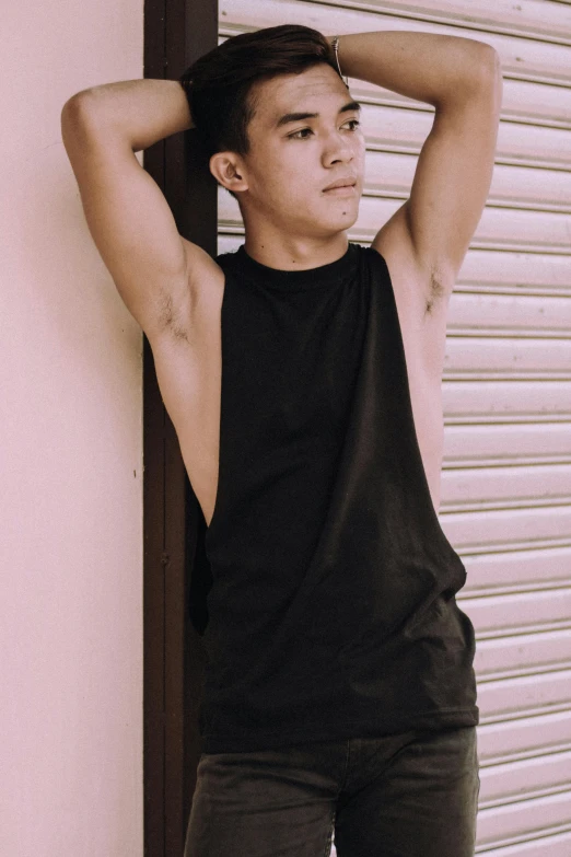 a man leaning against a wall with his hands on his head, inspired by Oliver Sin, trending on pexels, tachisme, black tanktop, fullbody, korean muscle boy 2 1 years old, halter neck
