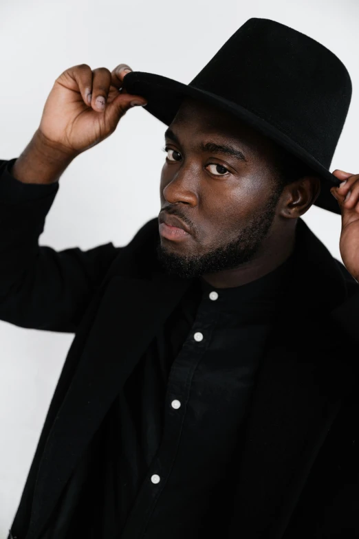 a man in a black suit and a black hat, an album cover, inspired by Theo Constanté, pexels contest winner, he is wearing a black t-shirt, kevin hart, ready to model, ignant