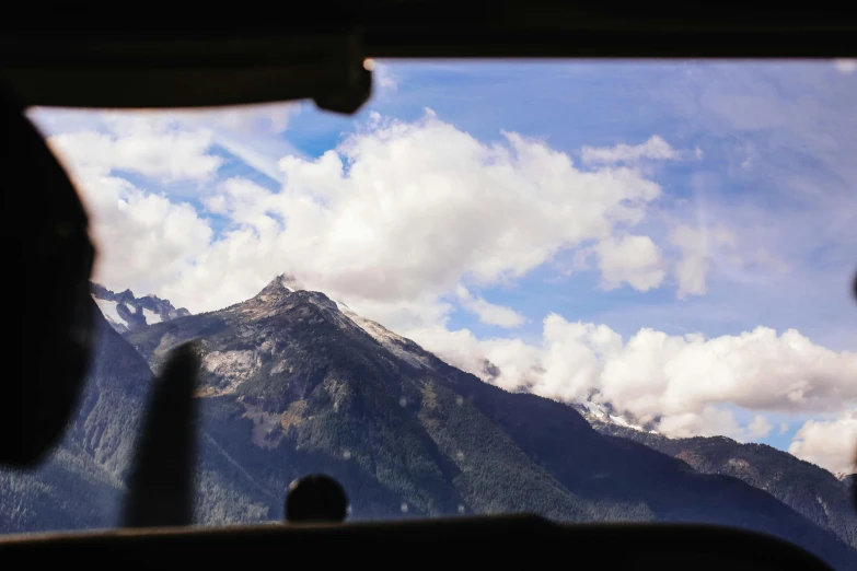 a view of the mountains from inside a vehicle, by Peter Churcher, unsplash, visual art, airplane view, whistler, conde nast traveler photo, fan favorite