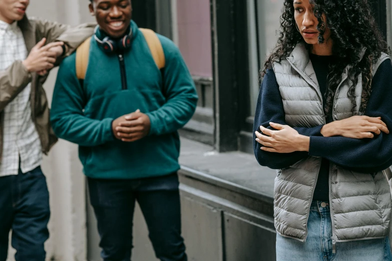 a group of people standing next to each other, by Nina Hamnett, trending on pexels, renaissance, beautiful city black woman only, background image, worried, a man wearing a backpack