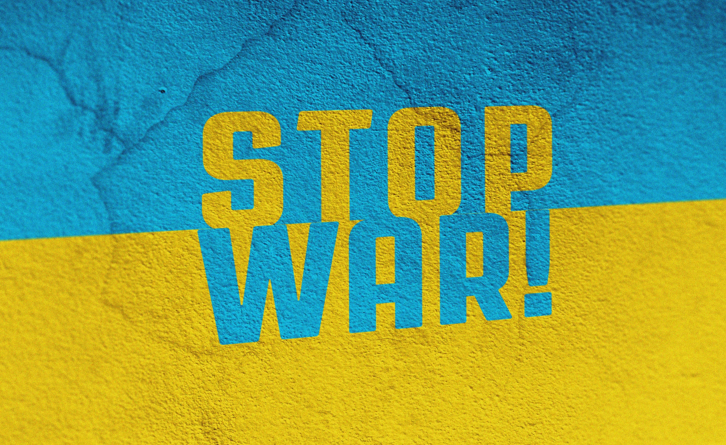 a stop war sign painted on the side of a building, an album cover, by Stefan Gierowski, shutterstock, yellow and blue and cyan, ukrainian, wallpaper - 1 0 2 4, fight ww 1