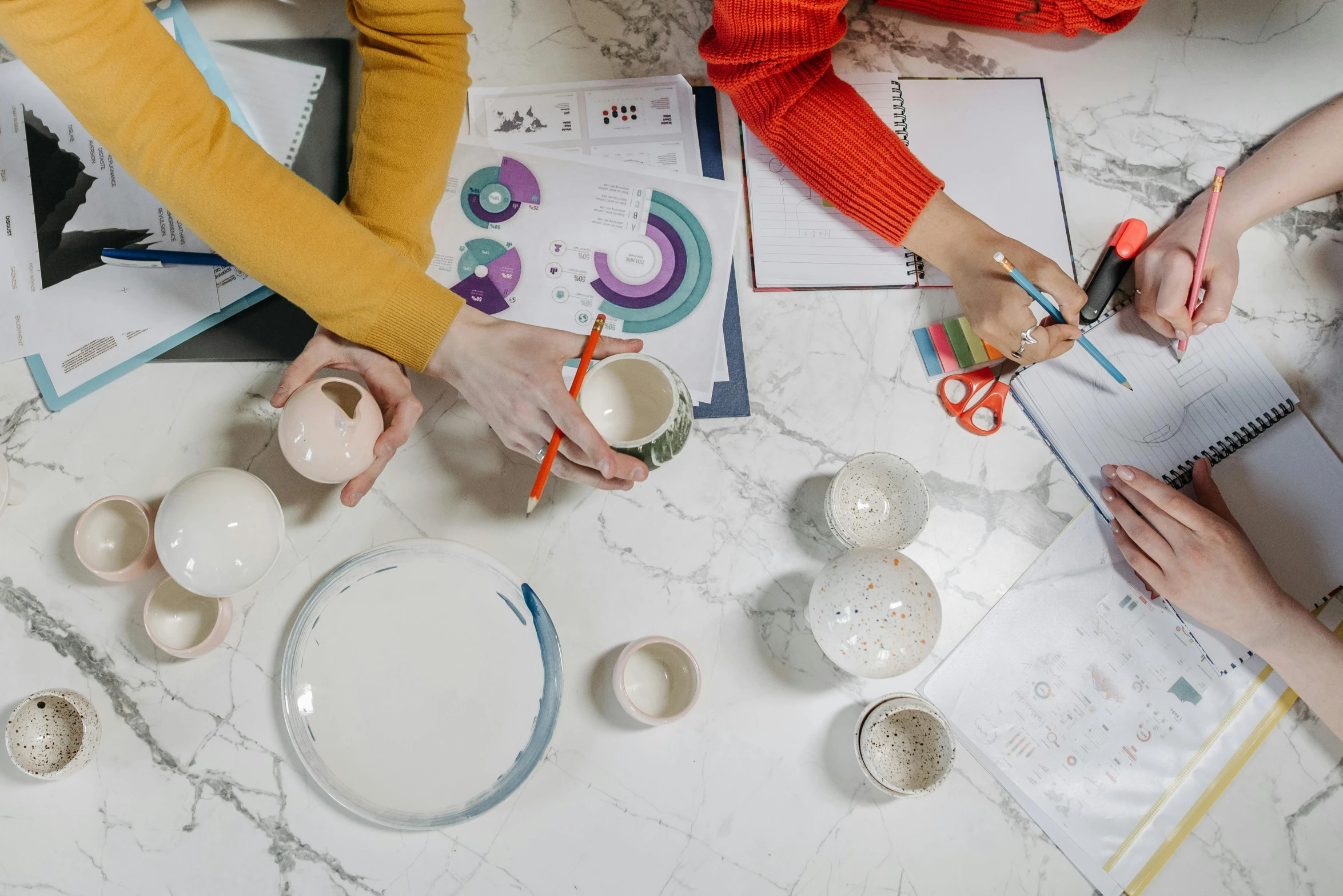 a group of people sitting around a table, by Arabella Rankin, trending on unsplash, arbeitsrat für kunst, cups and balls, emma bridgewater and paperchase, industrial design blueprint, professional product photo