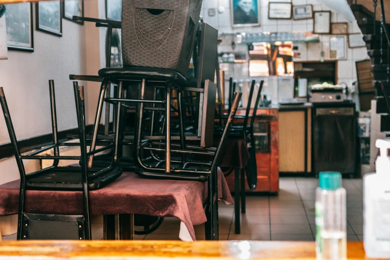 a bunch of chairs that are sitting in a room, a portrait, unsplash, les nabis, restaurant menu photo, unmistakably kenyan, belongings strewn about, at the counter