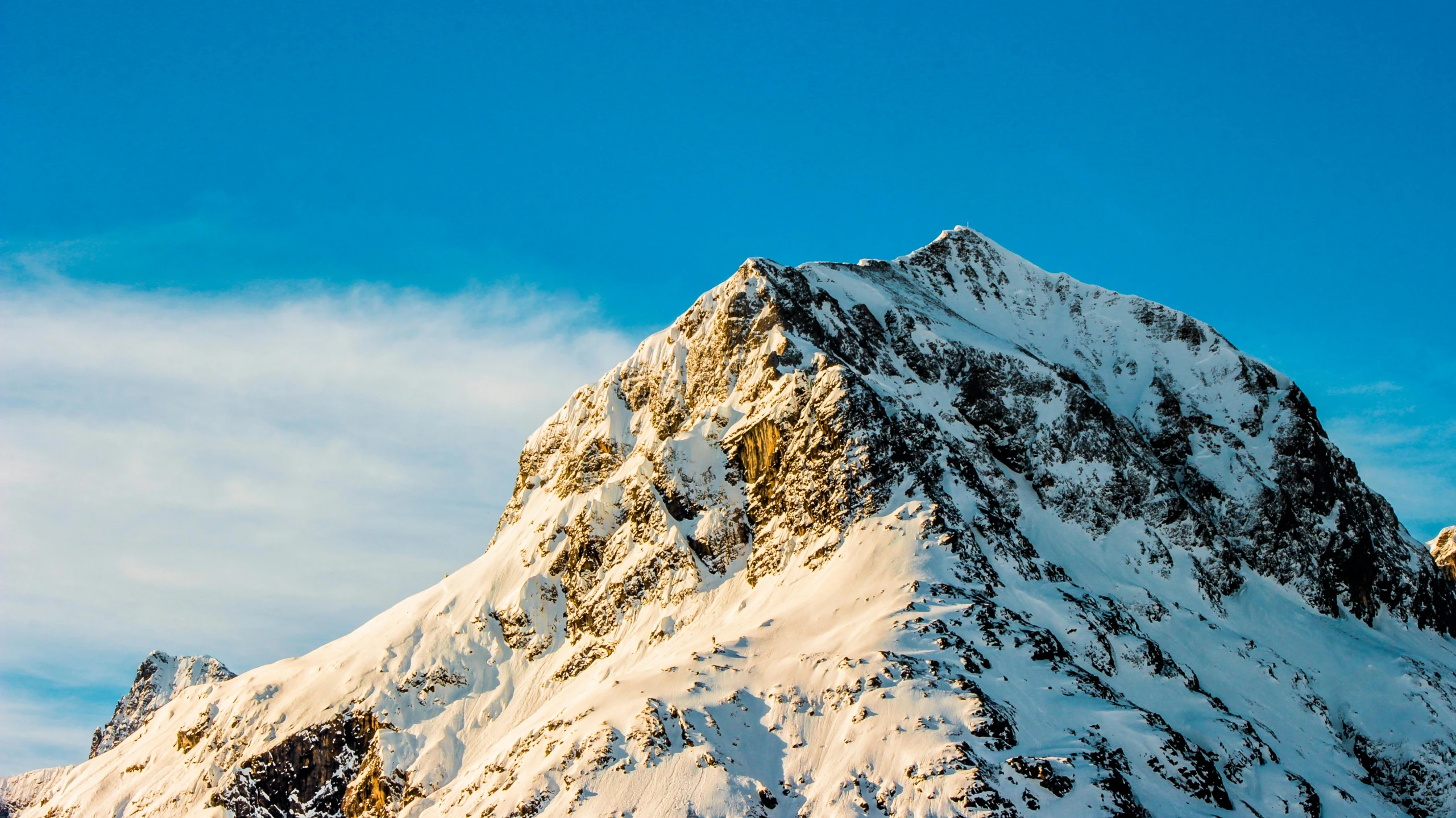 a man riding skis on top of a snow covered mountain, pexels contest winner, giant imposing mountain, avatar image, clear blue skies, early morning light