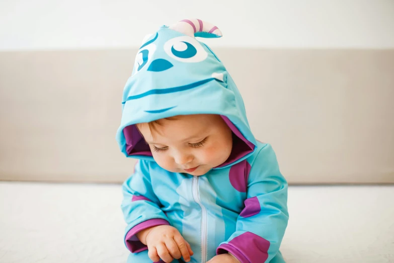a small child wearing a blue and purple costume, a cartoon, by disney, unsplash, zippers, sea creature, modelling, jacket