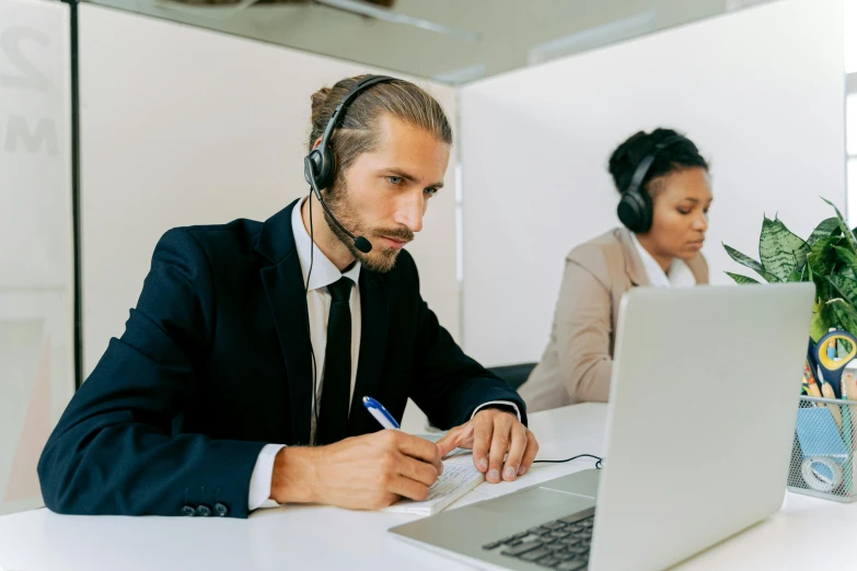 a man sitting in front of a laptop wearing a headset, by Jay Hambidge, pexels contest winner, hurufiyya, working in a call center, lachlan bailey, wearing business casual dress, thumbnail