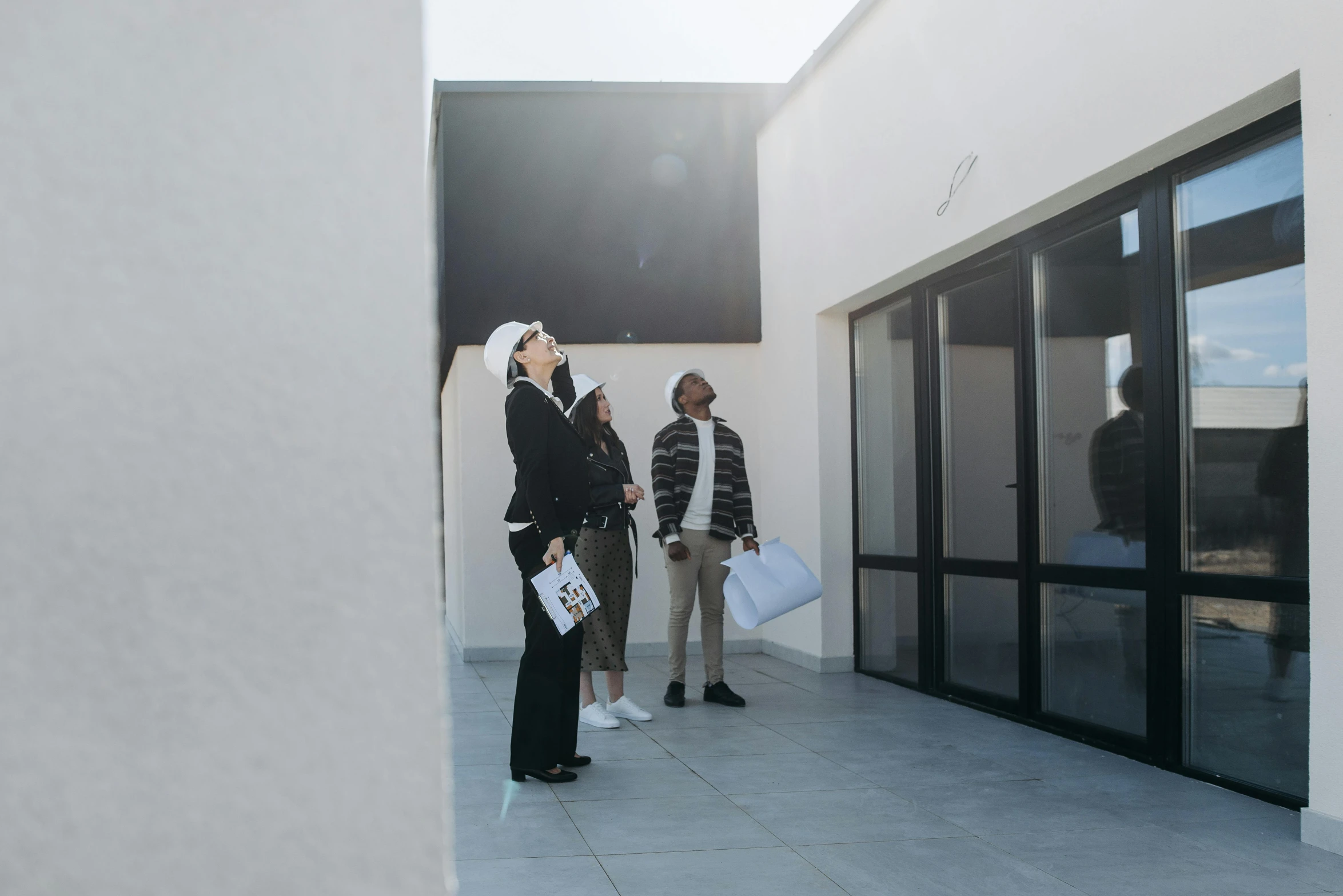 a group of people standing outside of a building, visual art, white sky, apartment, looking at the ceiling, day time