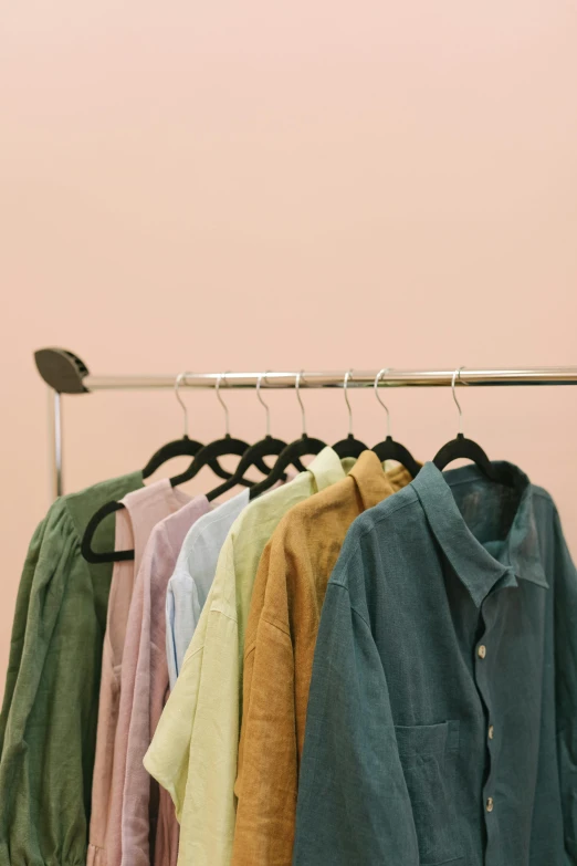 a row of shirts hanging on a rack, trending on unsplash, color field, wearing a light shirt, open shirt, subdued, color picture