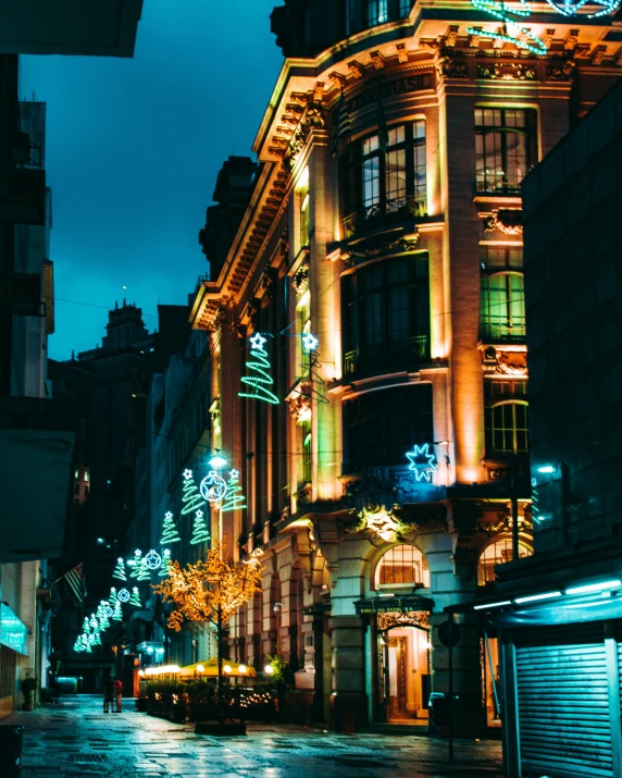 a street filled with lots of lights next to tall buildings, pexels contest winner, art nouveau, shop front, profile image, decorations, thumbnail