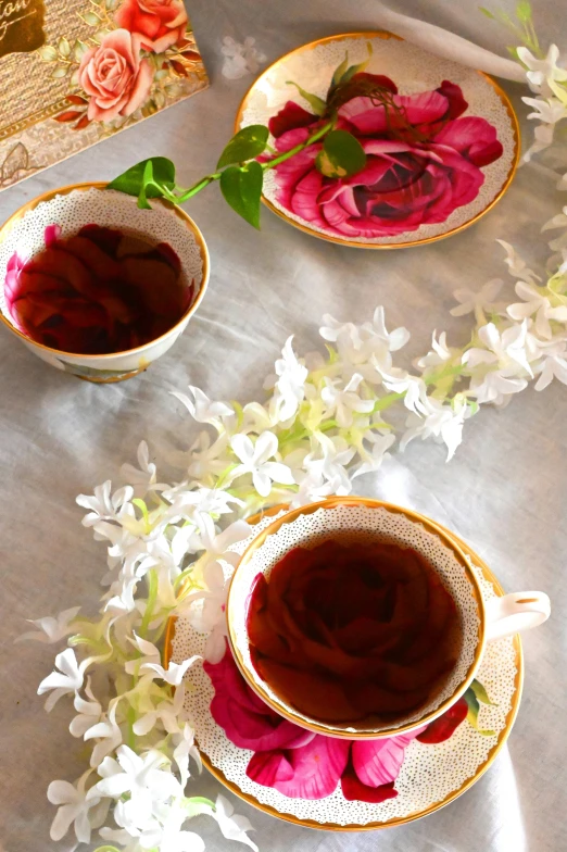 two cups of tea and a book on a table, by Pamela Ascherson, renaissance, clematis theme banner, sri lanka, promo image, bougainvillea