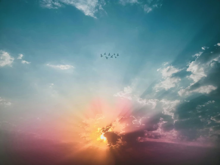 a group of birds flying through a cloudy sky, an album cover, pexels contest winner, minimalism, multiple suns, beeple |, color ( sony a 7 r iv, heavenly colors