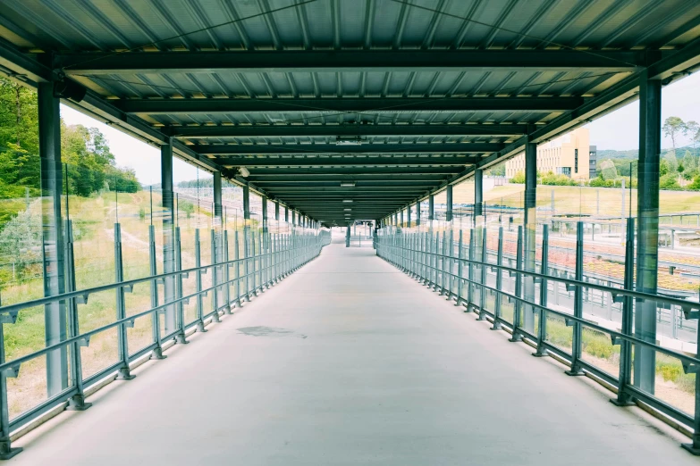 a long walkway leading to a train station, inspired by Andreas Gursky, unsplash, detention centre, sportspalast amphitheatre, canopies, instagram story