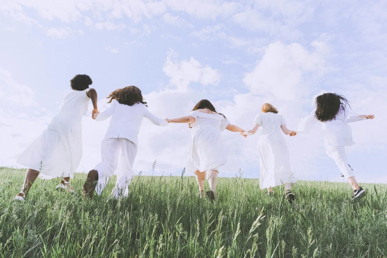 a group of people standing on top of a lush green field, girl in white dress dancing, dressed in a white t shirt, avatar image, photoshoot for skincare brand