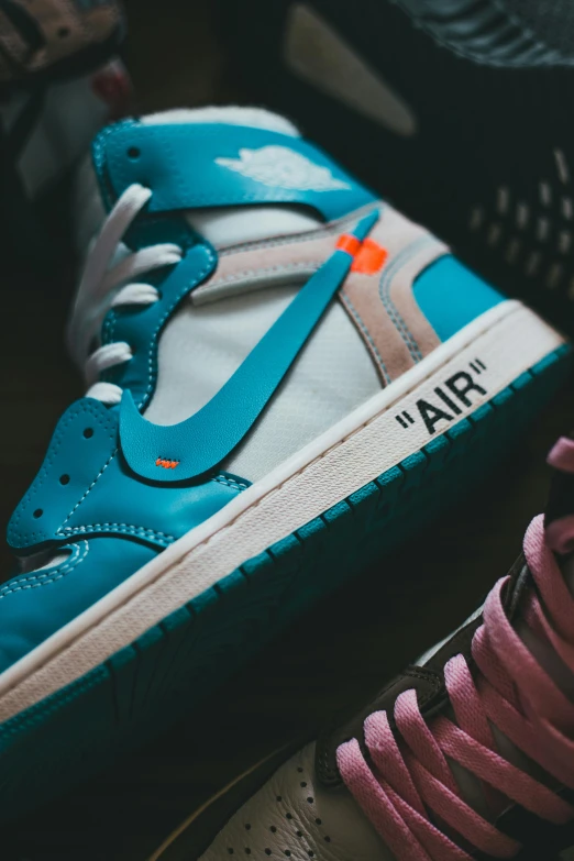 a pair of sneakers sitting on top of each other, cyan and orange, airborn studios, up-close, off - white