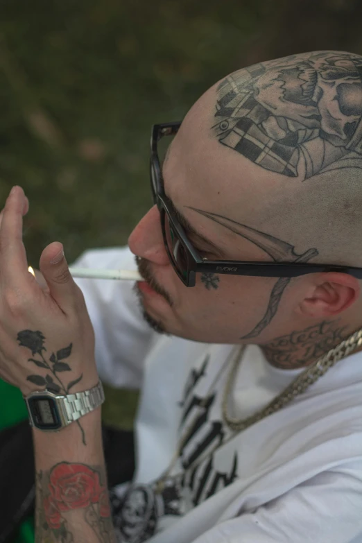 a man with a tattoo on his head smoking a cigarette, featured on reddit, outside alone smoking weed, outlines, a green, ice - t