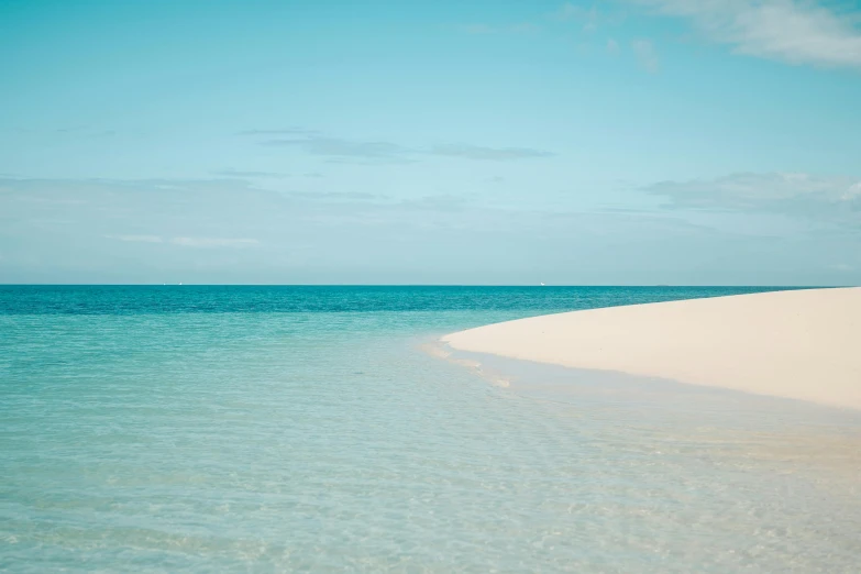 a couple of umbrellas sitting on top of a sandy beach, unsplash contest winner, minimalism, bahamas, white and pale blue, over water, madagascar