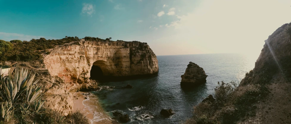 a large body of water next to a cliff, pexels contest winner, renaissance, arch, portugal, low quality footage, landscape photo