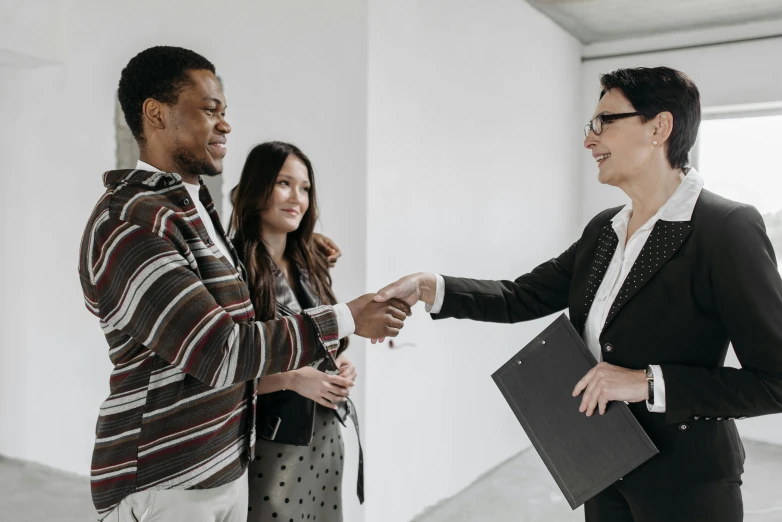 a group of people shaking hands in a room, selling insurance, ignant, varying ethnicities, professional modeling