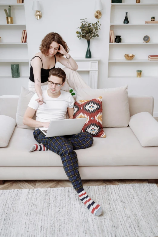 a man and woman sitting on a couch with a laptop, trending on pexels, renaissance, awkward, maxim shirkov, open plan, gif