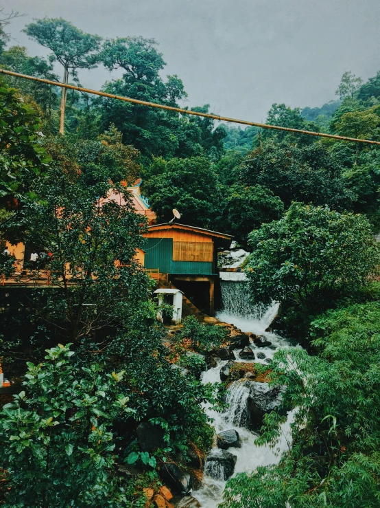 a river running through a lush green forest, by Alejandro Obregón, pexels contest winner, sumatraism, peaceful wooden mansion, 2 5 6 x 2 5 6 pixels, iphone photo, (waterfall)