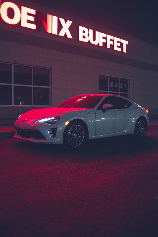 a car parked in front of a joe ix buffet, inspired by Elsa Bleda, unsplash contest winner, soft red lights, toyota supra, monochromatic, gif