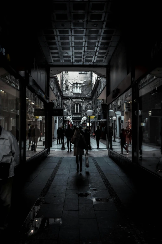 a group of people walking down a dark street, pexels contest winner, renaissance, exiting store, madrid, in a massive cavernous iron city, melbourne