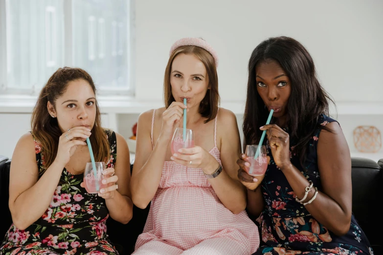 three women sitting on a couch drinking drinks, by Emma Andijewska, trending on pexels, happening, maternity feeling, pink and teal, avatar image, with a straw