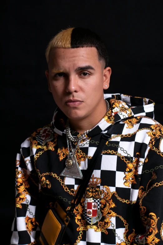 a man with a chain around his neck, an album cover, inspired by Carlos Berlanga, wearing gold chain, looking serious, 2019 trending photo, velasquez