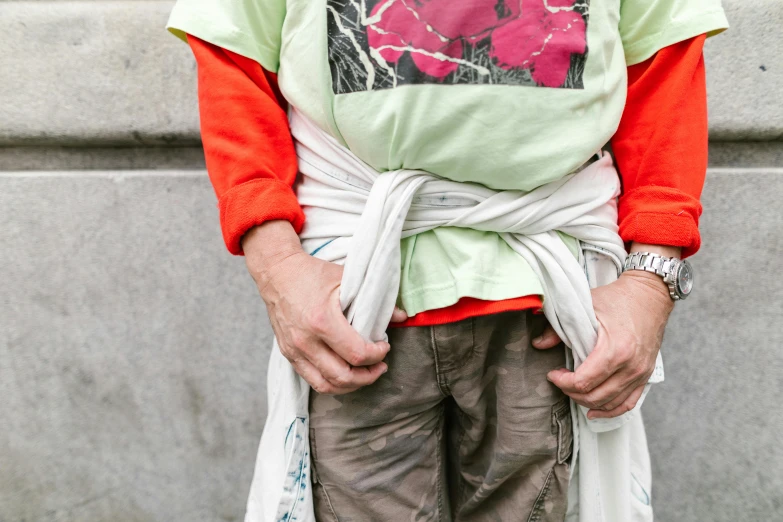 a man with a tie around his waist, inspired by Sarah Lucas, unsplash, visual art, wearing ragged clothing, colourful clothes, wearing a white gi, begging