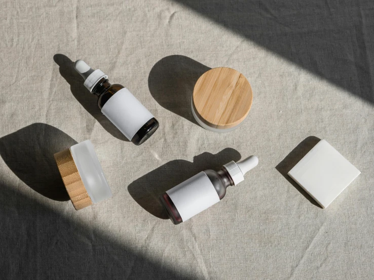 a couple of bottles sitting on top of a table, unsplash, assemblage, skincare, made of bamboo, organic ceramic white, pack