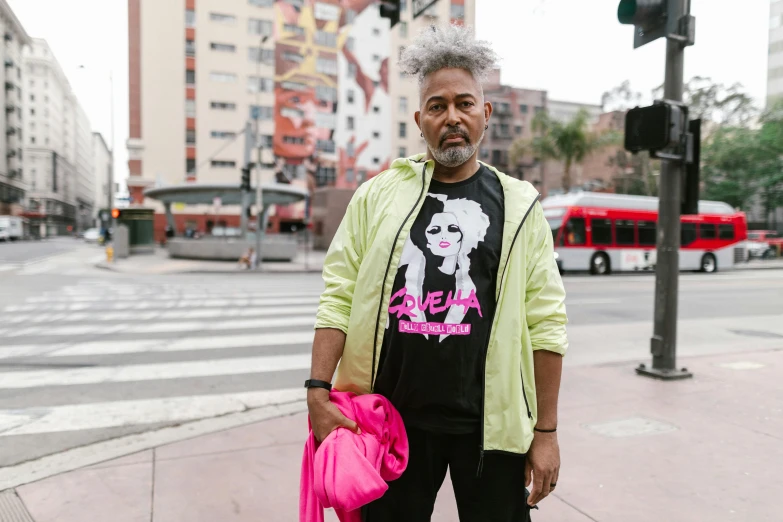 a man standing on a city street holding a pink bag, by Winona Nelson, neo-dada, wearing silver hair, ivan bolivian, neon pink and black color scheme, eloy morales